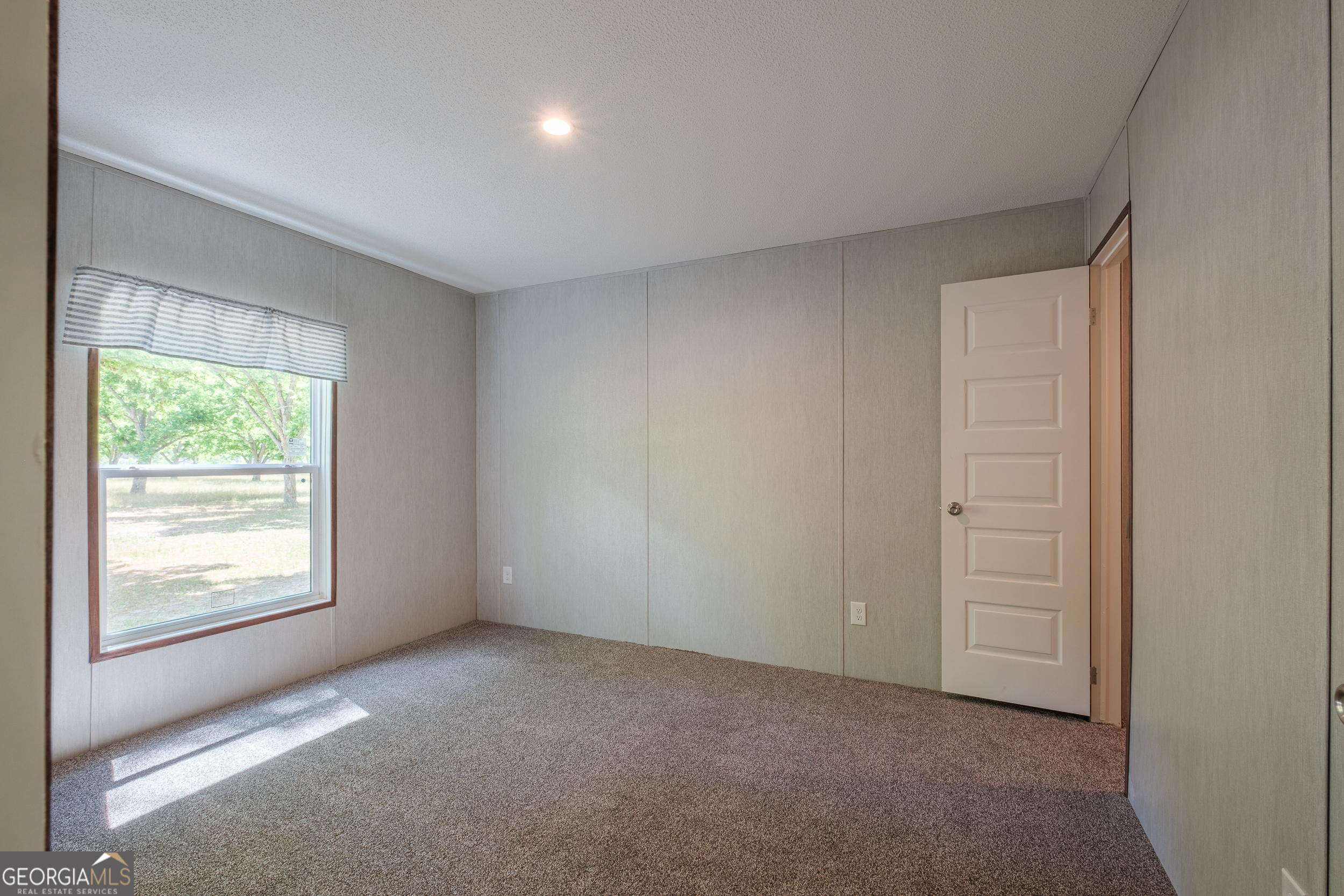 2853 Lake Lannell Road Odum, GA 31555 - Photo 23 of 29 an empty room with windows and closet