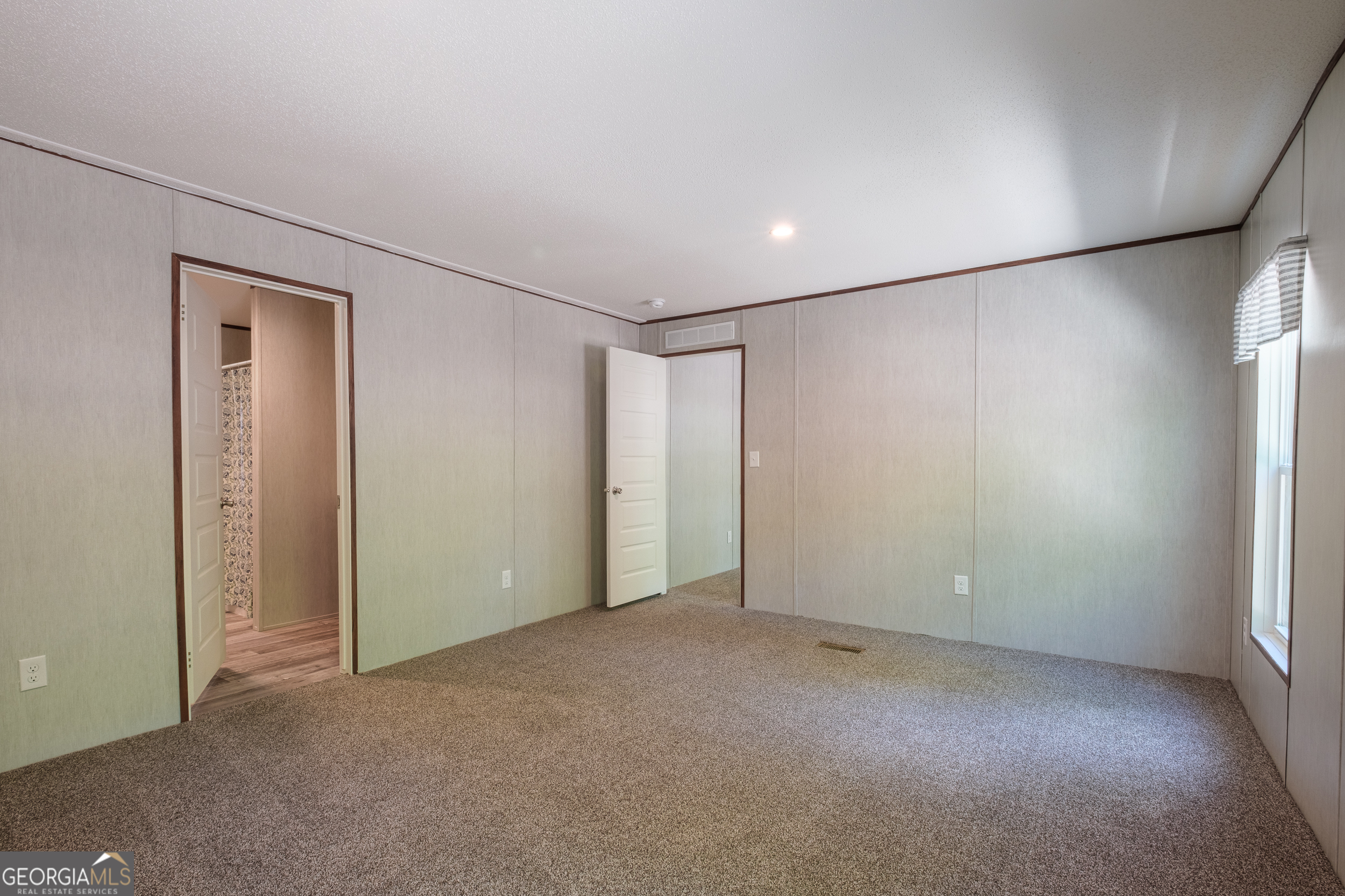 2853 Lake Lannell Road Odum, GA 31555 - Photo 8 of 29 an empty room with closet and windows