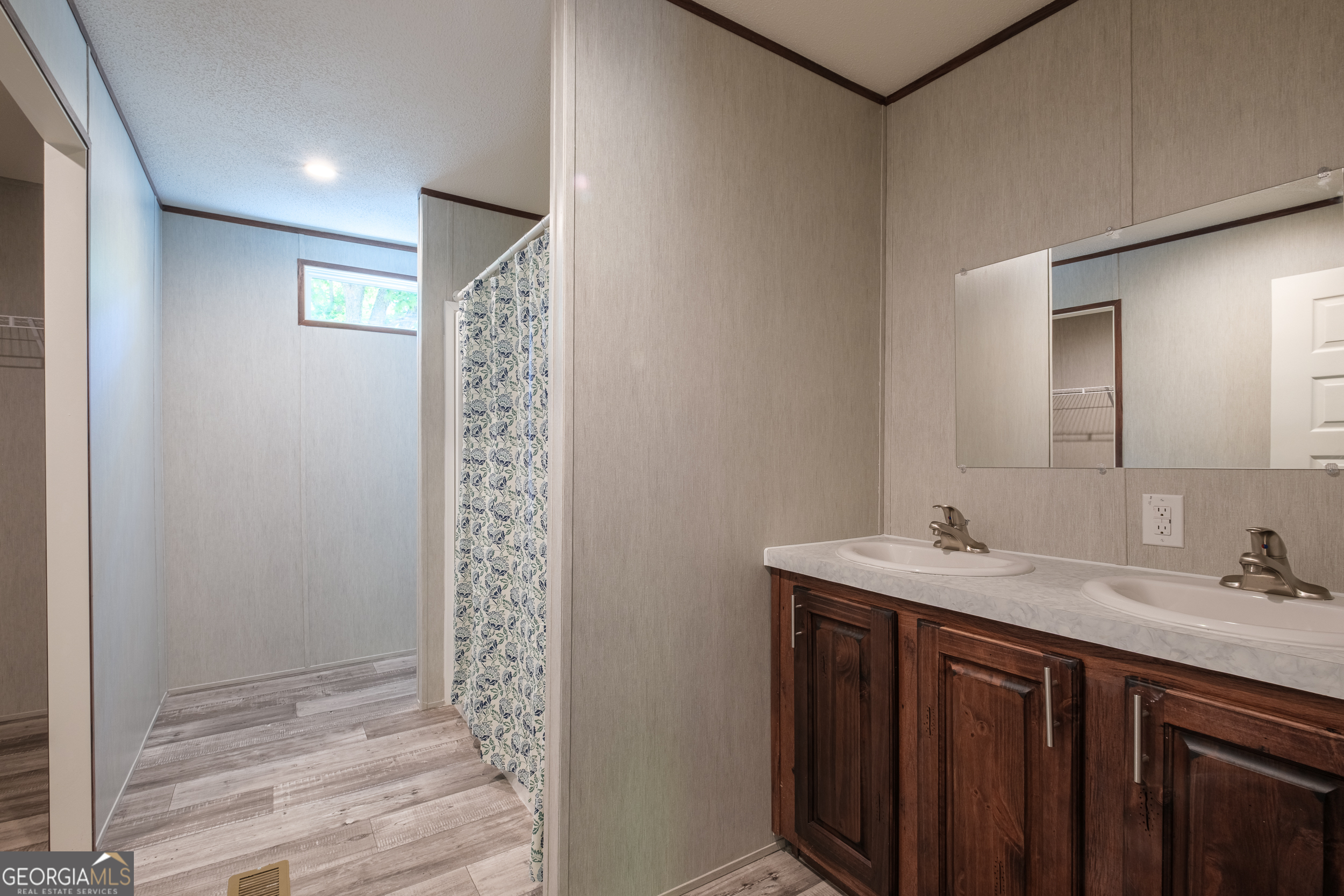 2853 Lake Lannell Road Odum, GA 31555 - Photo 9 of 29 a bathroom with a sink a mirror and shower