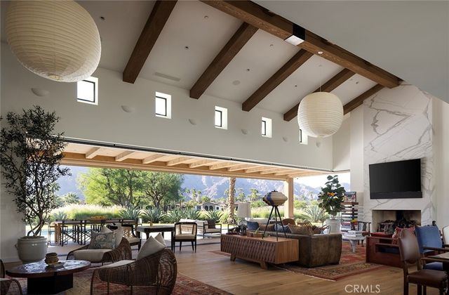 a living room with patio furniture and a potted plants