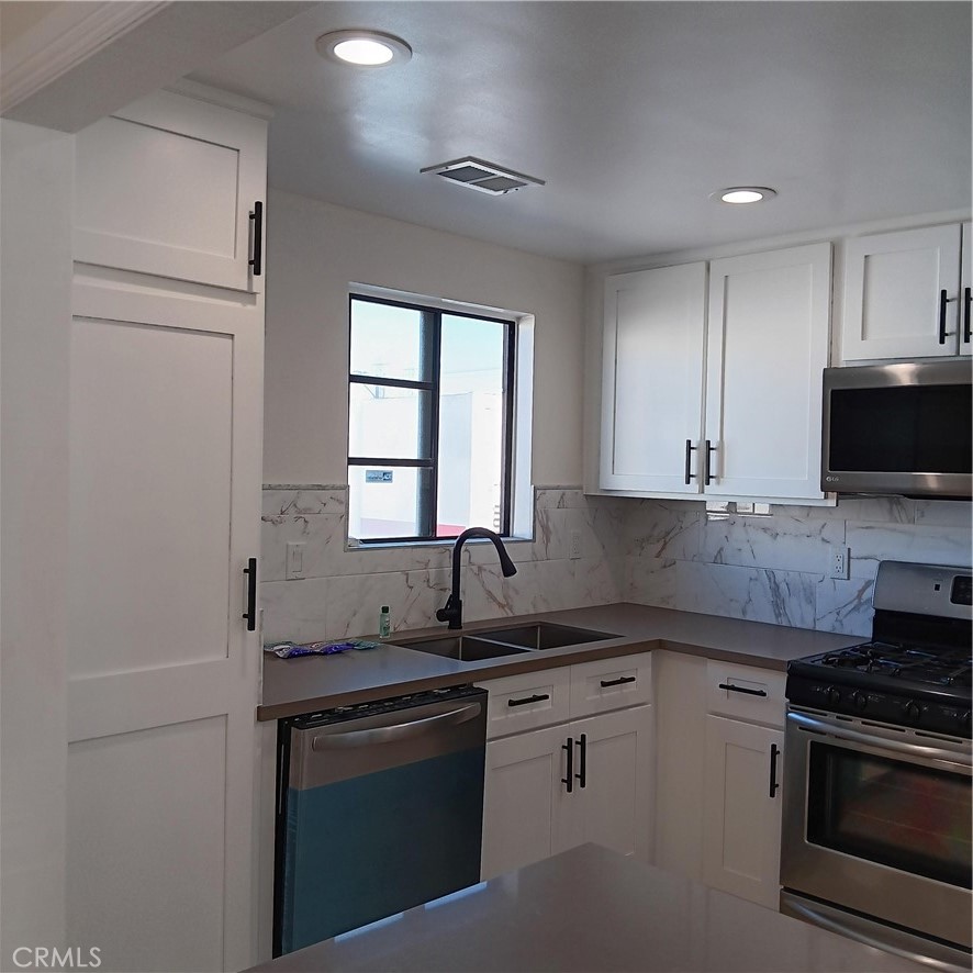 1419 West 179th Street, Unit 16 Gardena, CA 90248 - Photo 2 of 48 a kitchen with granite countertop a sink stainless steel appliances and cabinets