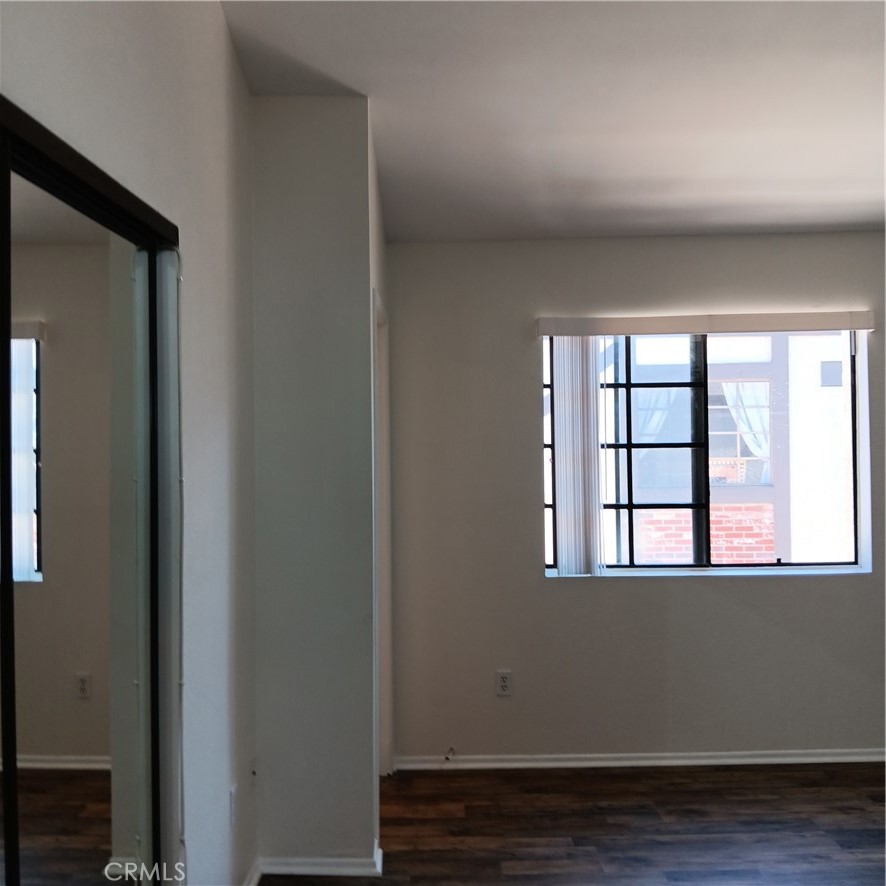 1419 West 179th Street, Unit 16 Gardena, CA 90248 - Photo 26 of 48 a view of an empty room with wooden floor and a window