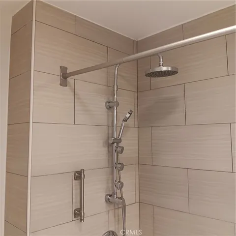 a white toilet sitting next to a shower