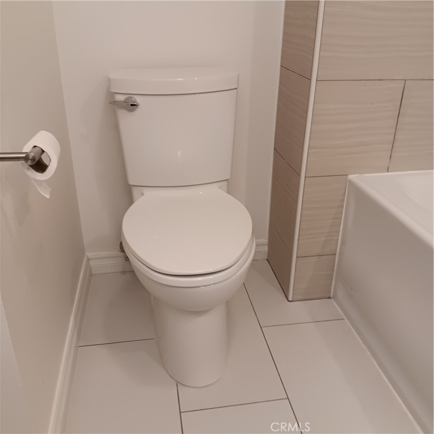 1419 West 179th Street, Unit 16 Gardena, CA 90248 - Photo 32 of 48 a white toilet sitting next to a shower