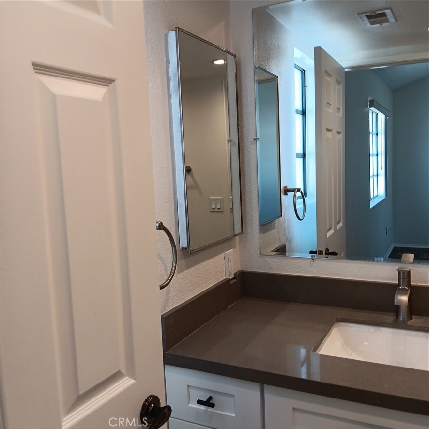 1419 West 179th Street, Unit 16 Gardena, CA 90248 - Photo 37 of 48 a bathroom with a sink and a mirror