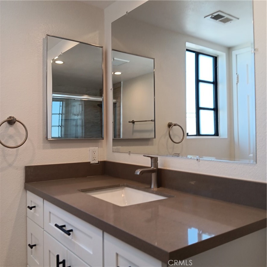 1419 West 179th Street, Unit 16 Gardena, CA 90248 - Photo 38 of 48 a bathroom with a sink and a mirror