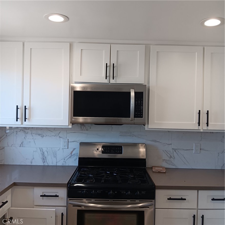 1419 West 179th Street, Unit 16 Gardena, CA 90248 - Photo 42 of 48 a close view of a stove a microwave and cabinets in the kitchen
