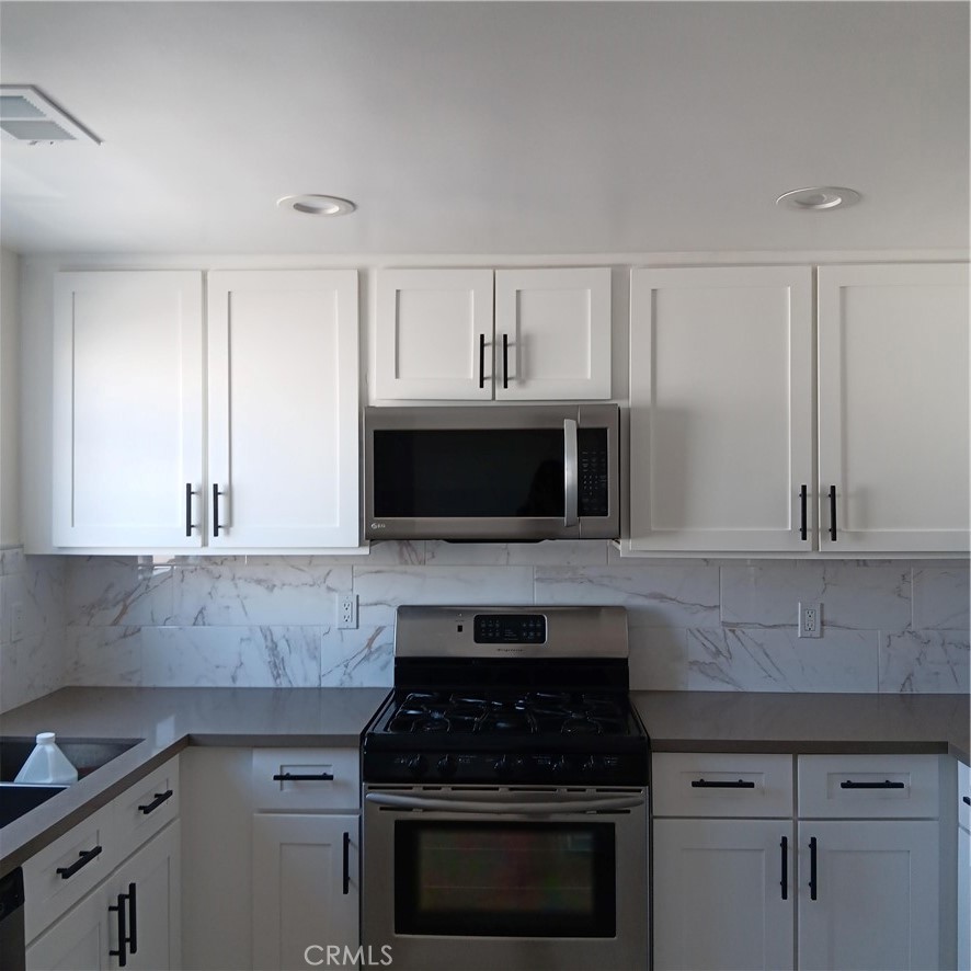 1419 West 179th Street, Unit 16 Gardena, CA 90248 - Photo 44 of 48 a kitchen with cabinets stainless steel appliances a sink and a stove