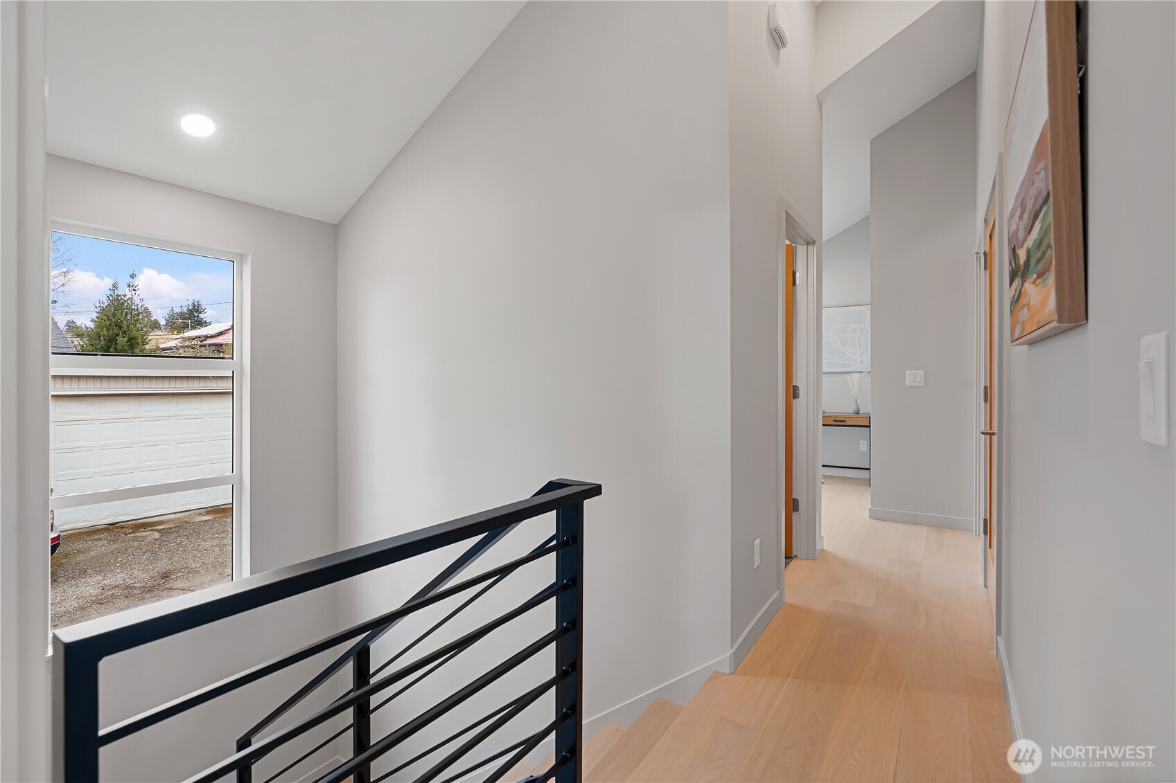 3412 Northwest 56th Street Seattle, WA 98107 - Photo 20 of 26 a view of a hallway with wooden floor and stairs