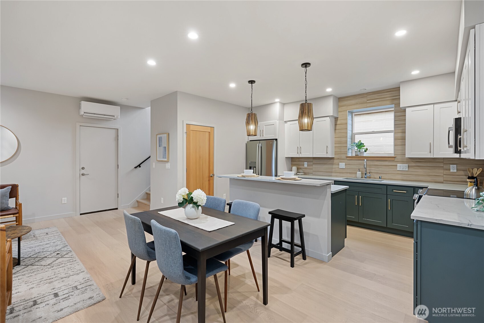 3412 Northwest 56th Street Seattle, WA 98107 - Photo 6 of 26 a kitchen with a table chairs sink and cabinets