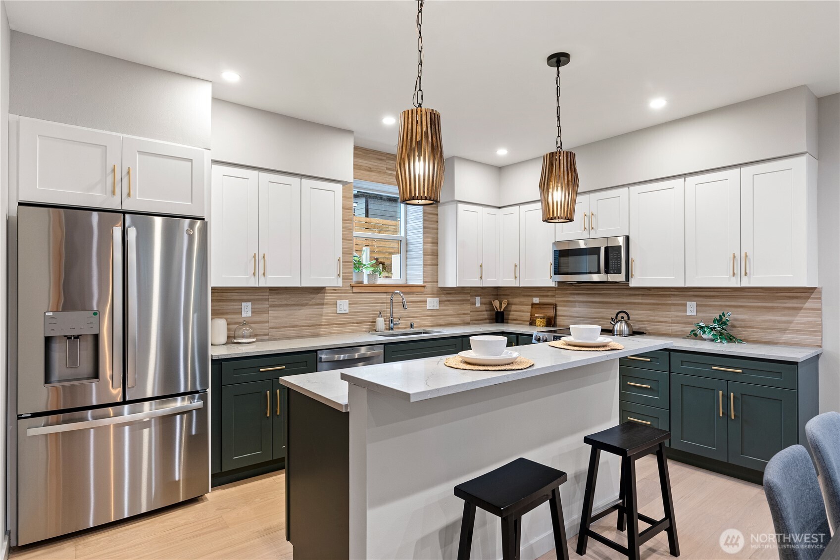 3412 Northwest 56th Street Seattle, WA 98107 - Photo 8 of 26 a kitchen with kitchen island white cabinets and stainless steel appliances