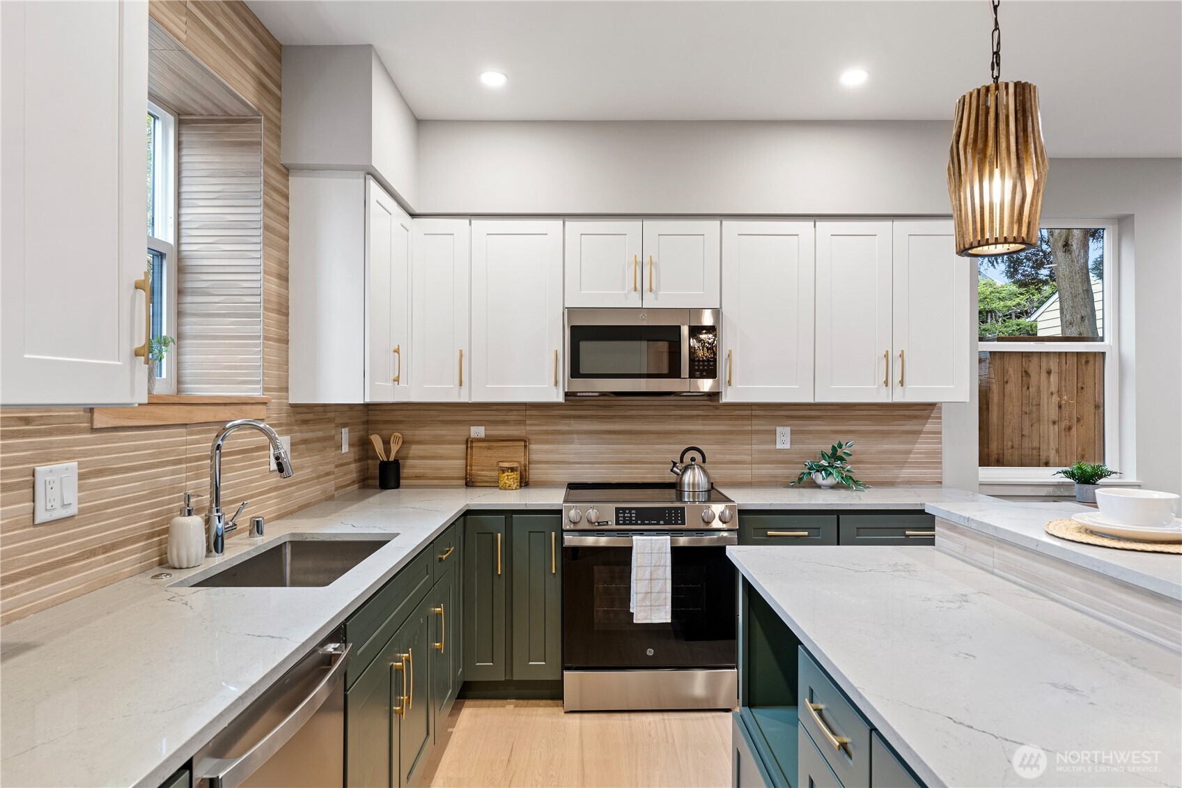 3412 Northwest 56th Street Seattle, WA 98107 - Photo 9 of 26 a kitchen with a sink a stove and cabinets
