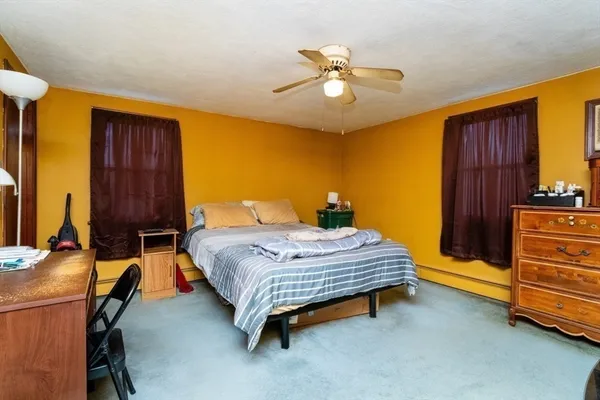 a bed room with a bed furniture and a ceiling fan