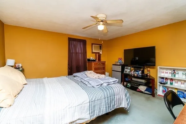 a bedroom with a bed and a chandelier