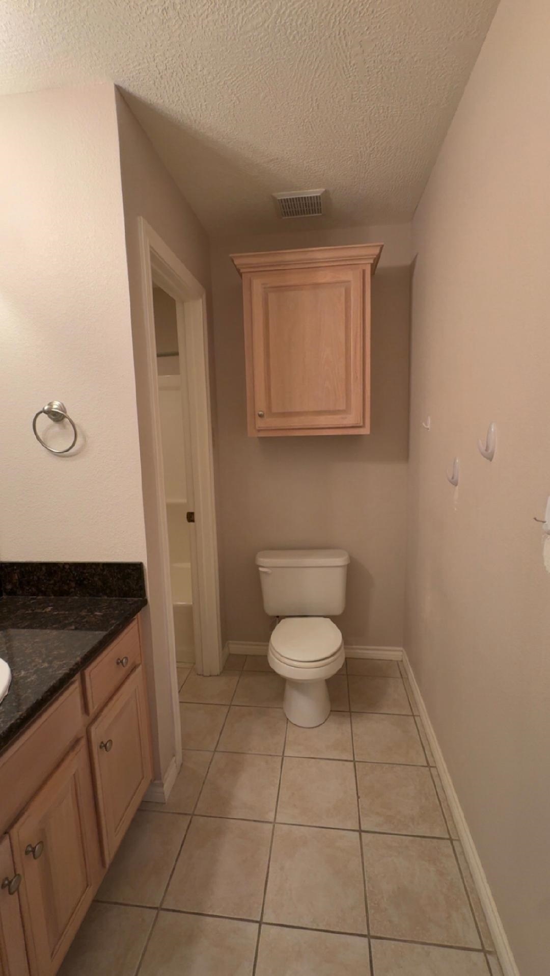 4665 Glen Oaks Circle Beaumont, TX 77708 - Photo 13 of 20 a spacious bathroom with a granite countertop toilet and a sink
