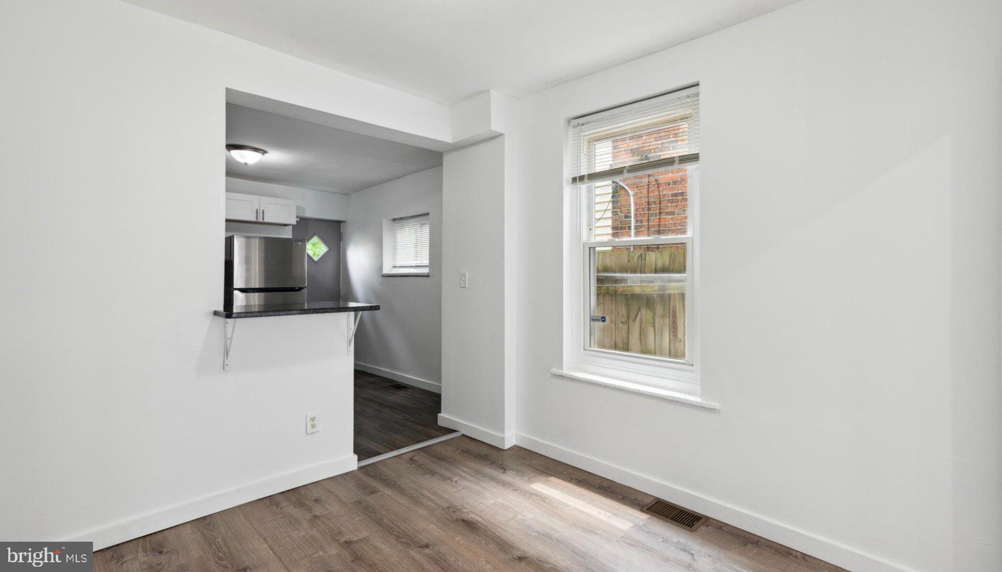 17 South 45th Street Philadelphia, PA 19104 - Photo 11 of 13 an empty room with wooden floor mirror and windows