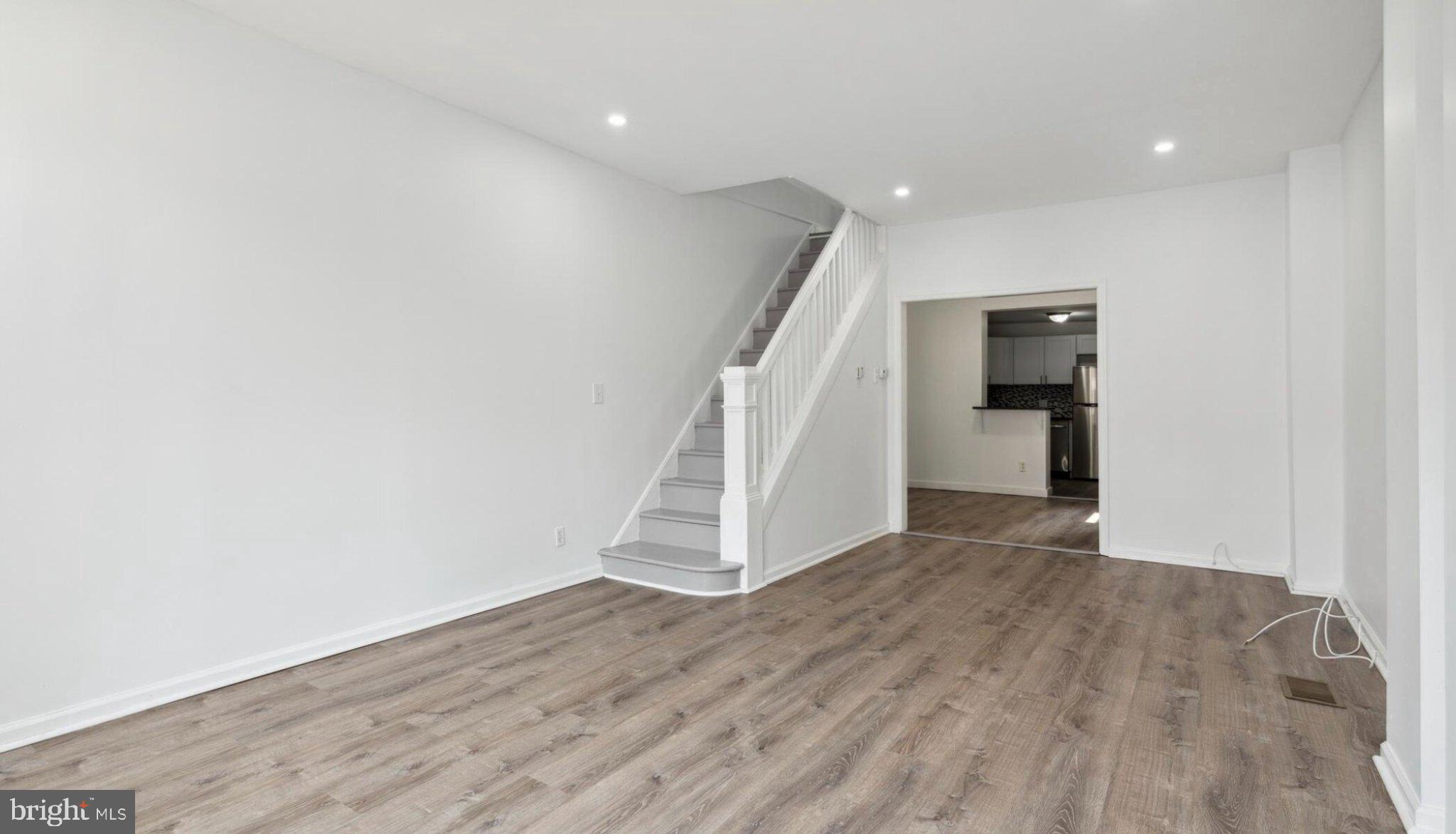 17 South 45th Street Philadelphia, PA 19104 - Photo 4 of 13 a view of an empty room with wooden floor and stairs