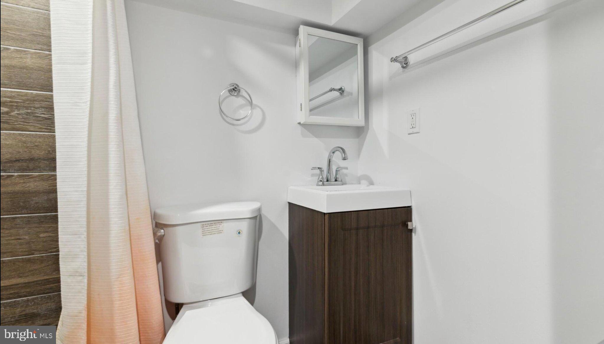 17 South 45th Street Philadelphia, PA 19104 - Photo 7 of 13 a bathroom with a toilet sink and mirror