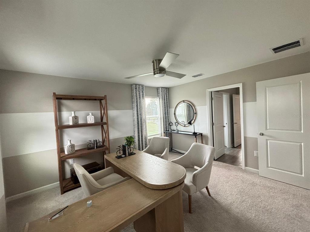 4738 Southwest 83rd Loop Ocala, FL 34476 - Photo 12 of 17 a living room with furniture a window and a fireplace