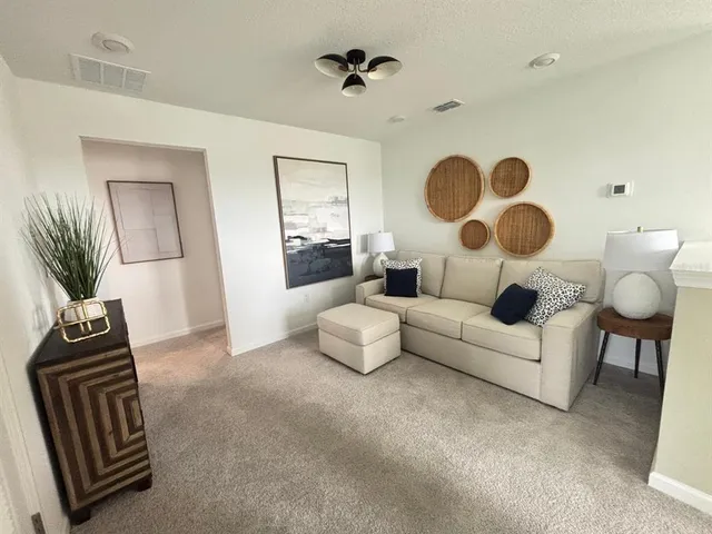a living room with furniture and a chandelier