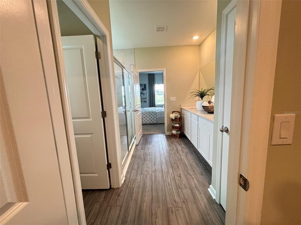 4738 Southwest 83rd Loop Ocala, FL 34476 - Photo 15 of 17 a view of a hallway with wooden floor and staircase