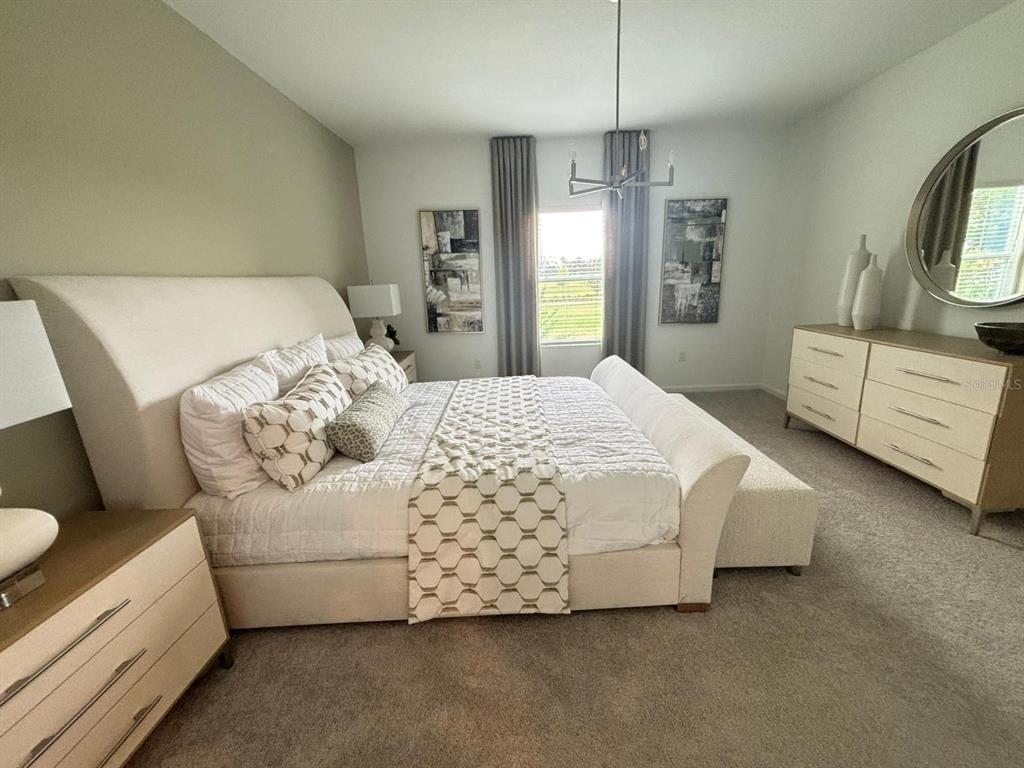 4738 Southwest 83rd Loop Ocala, FL 34476 - Photo 16 of 17 a bedroom with a bed a couch and dresser