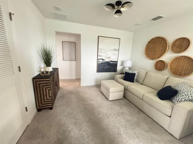 a living room with furniture and a chandelier