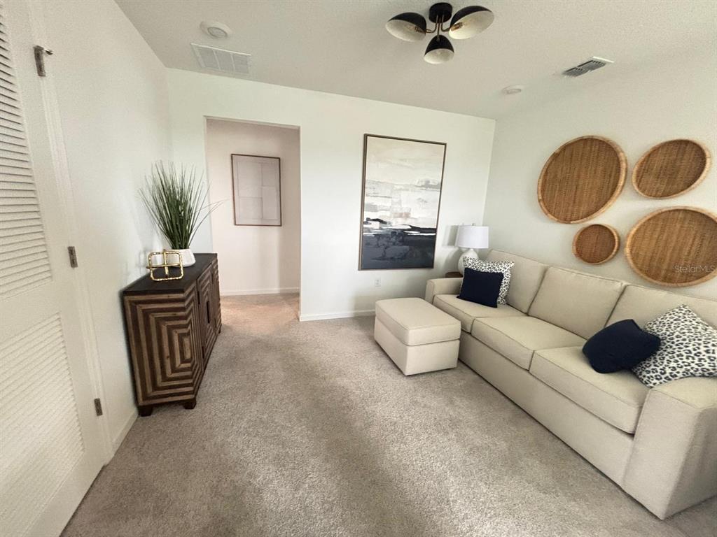 4738 Southwest 83rd Loop Ocala, FL 34476 - Photo 17 of 17 a living room with furniture and a chandelier