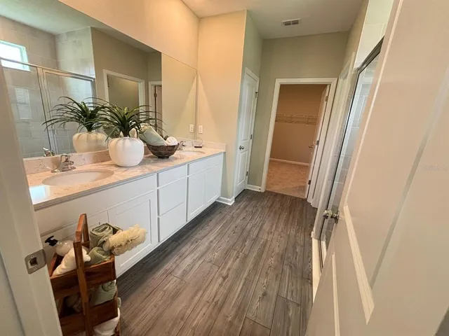 a bathroom with a sink mirror and vanity
