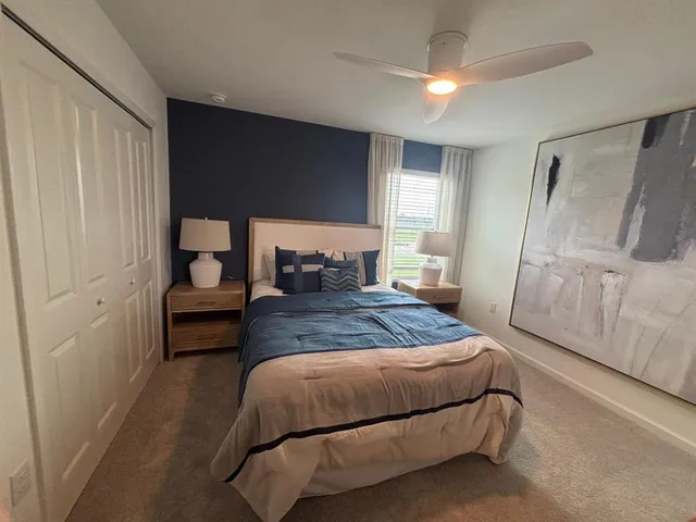 a bedroom with a bed and a mirror