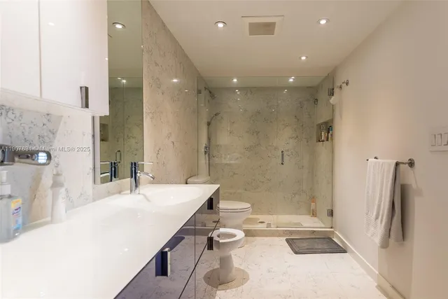 a bathroom with a bathtub shower sink and toilet