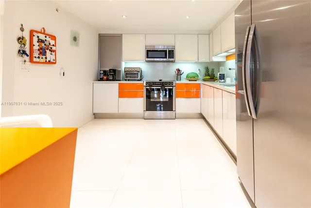 a view of a kitchen with a sink and a refrigerator
