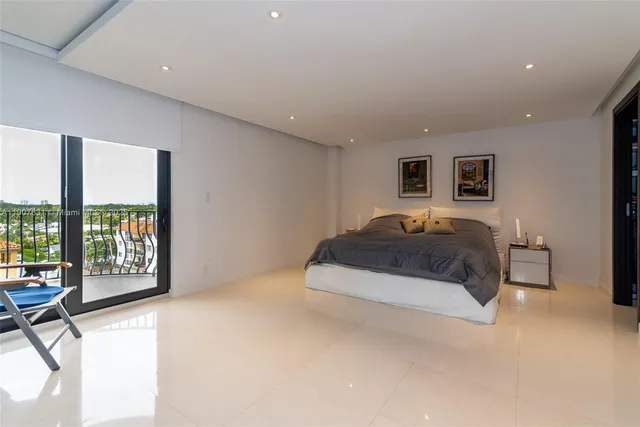 a spacious bedroom with a large bed and a large window