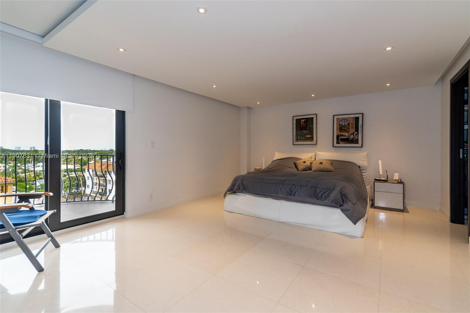 8877 Collins Avenue, Unit 604 Surfside, FL 33154 - Photo 10 of 25 a spacious bedroom with a large bed and a large window