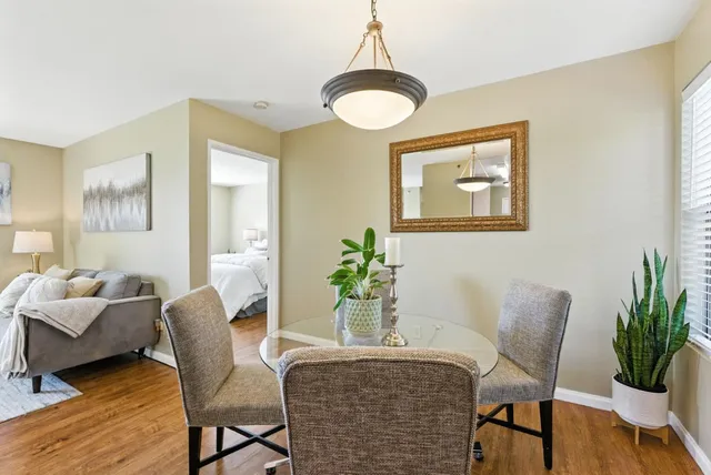 a dining room with furniture and wooden floor
