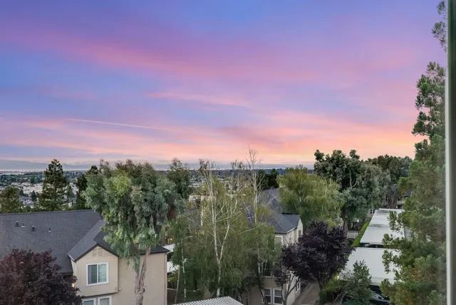 a view of a city with lush green forest