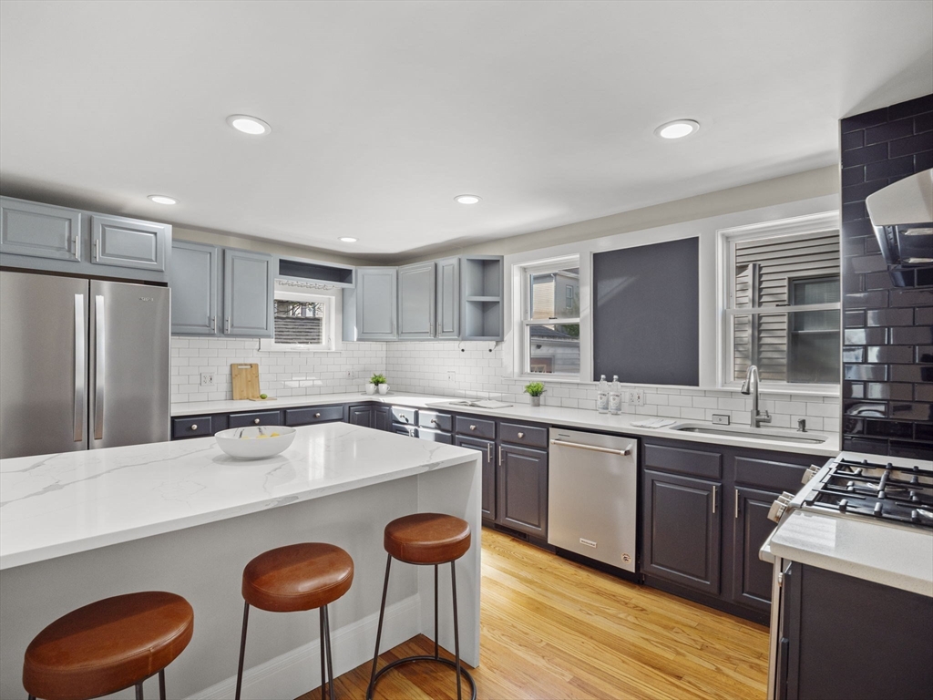 30 Baker Road Everett, MA 02149 - Photo 14 of 42 a kitchen with stainless steel appliances granite countertop a sink stove and refrigerator