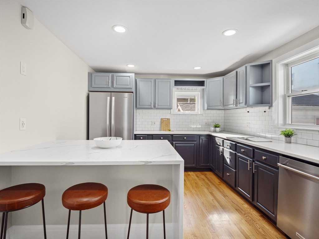 30 Baker Road Everett, MA 02149 - Photo 15 of 42 a kitchen with stainless steel appliances granite countertop a counter top space cabinets and a sink