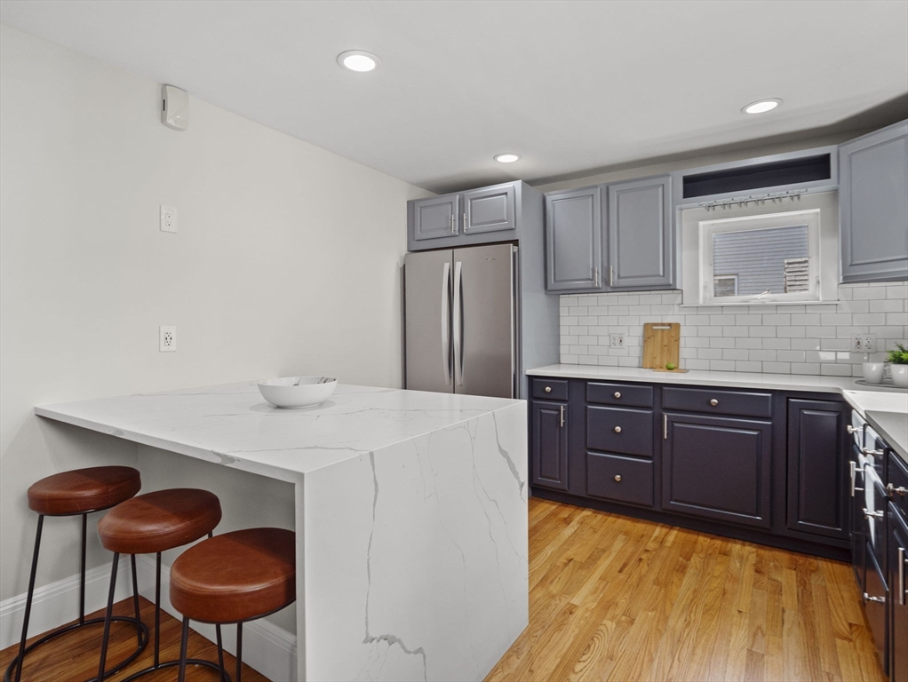 30 Baker Road Everett, MA 02149 - Photo 16 of 42 a kitchen with a refrigerator a stove and a dining table