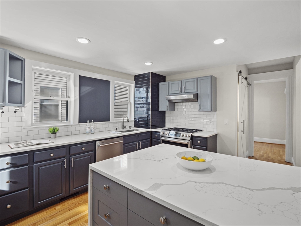30 Baker Road Everett, MA 02149 - Photo 17 of 42 a kitchen with a sink a stove and cabinets