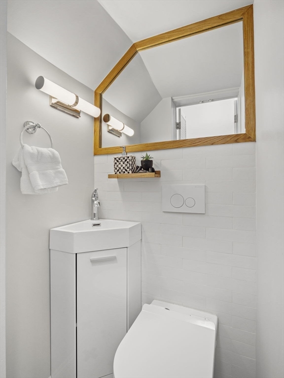 30 Baker Road Everett, MA 02149 - Photo 19 of 42 a bathroom with a sink a toilet and mirror