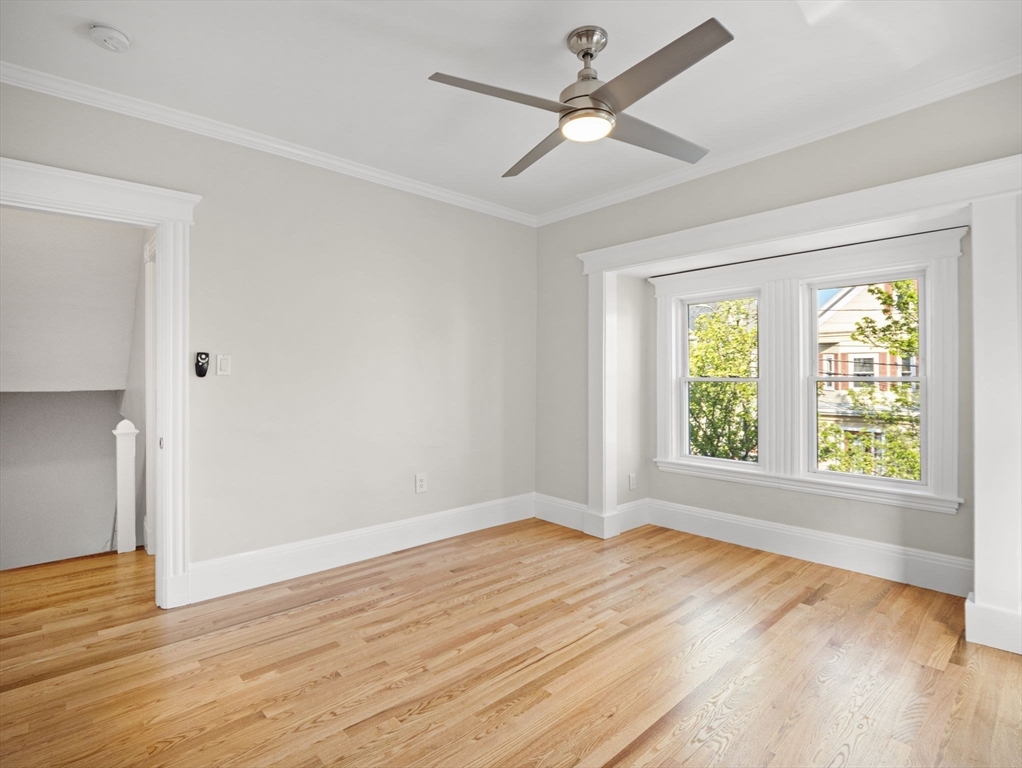 30 Baker Road Everett, MA 02149 - Photo 20 of 42 a view of an empty room with wooden floor and a window