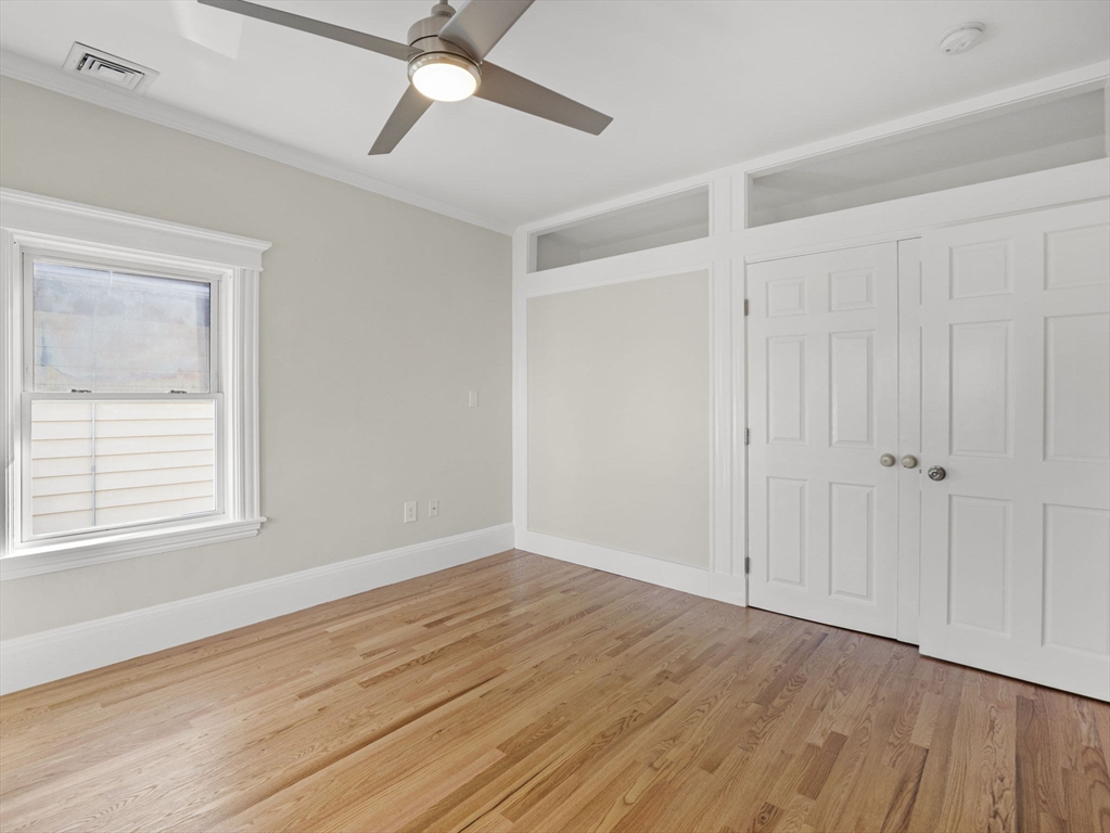 30 Baker Road Everett, MA 02149 - Photo 22 of 42 a view of an empty room with wooden floor and a window