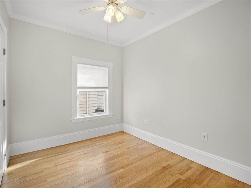 30 Baker Road Everett, MA 02149 - Photo 23 of 42 an empty room with wooden floor and windows