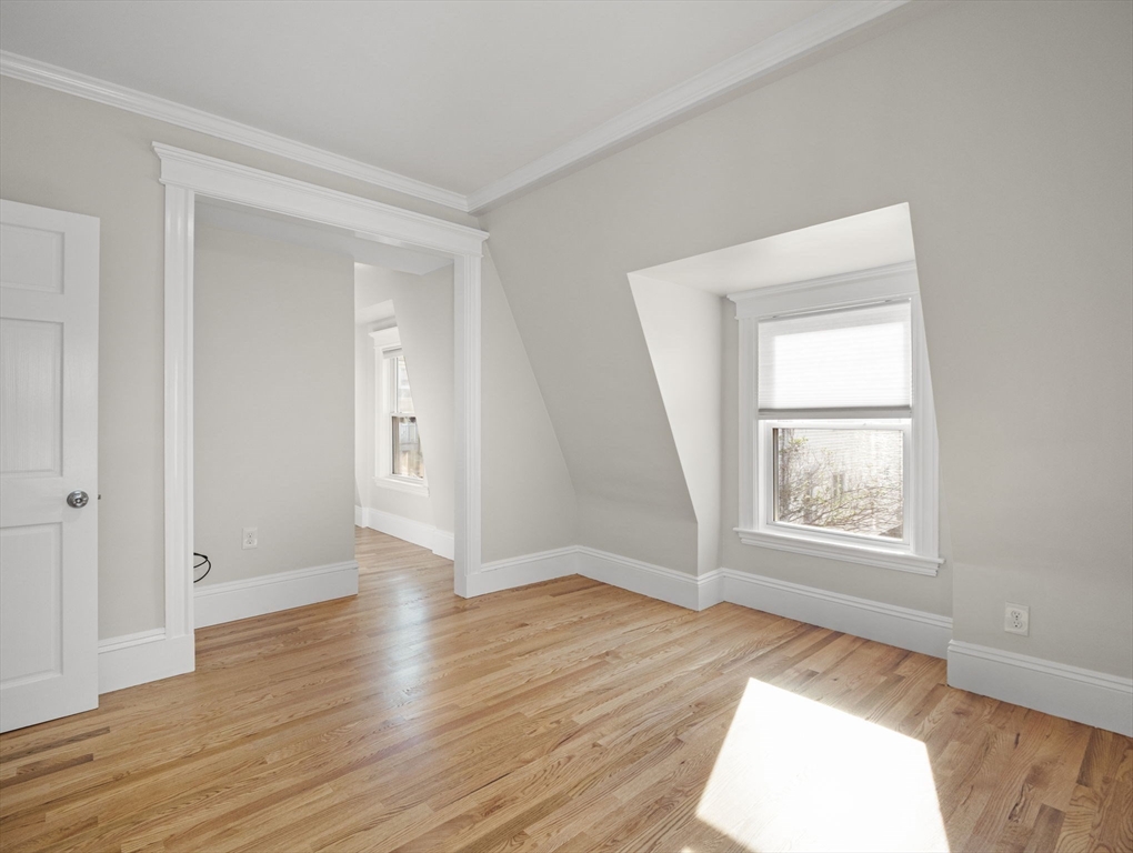 30 Baker Road Everett, MA 02149 - Photo 25 of 42 an empty room with wooden floor and windows
