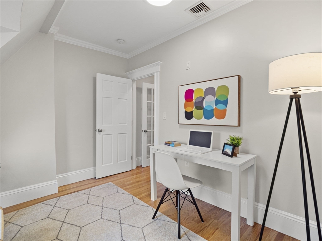 30 Baker Road Everett, MA 02149 - Photo 29 of 42 a view of a workspace with furniture and wooden floor