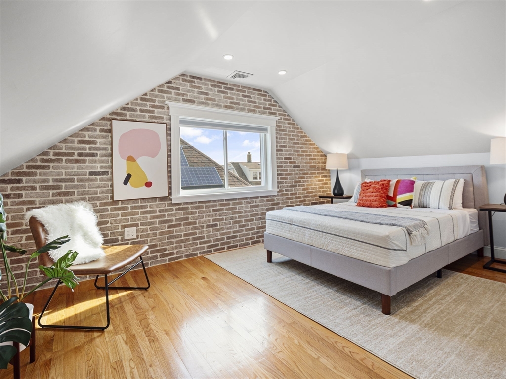 30 Baker Road Everett, MA 02149 - Photo 32 of 42 a bedroom with a bed and chair