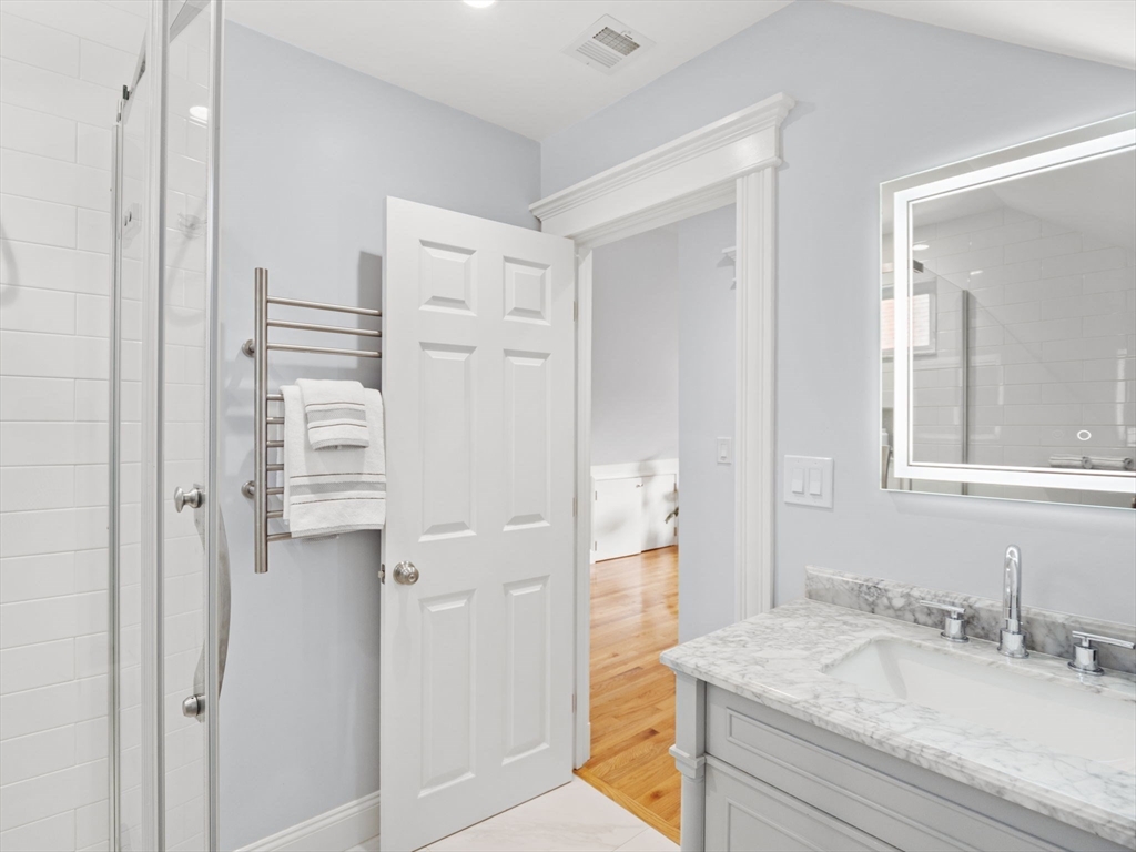 30 Baker Road Everett, MA 02149 - Photo 34 of 42 a bathroom with a granite countertop sink and a mirror