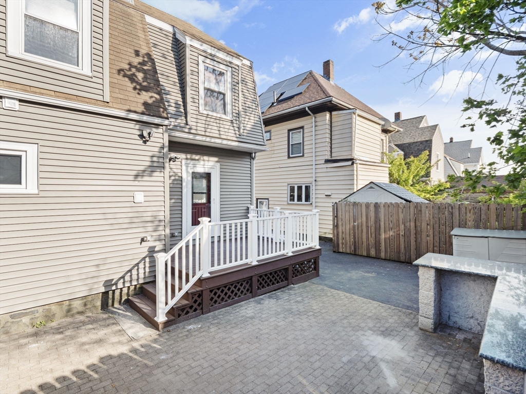 30 Baker Road Everett, MA 02149 - Photo 38 of 42 a view of a house with a yard and deck