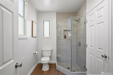 a bathroom with a toilet and a shower